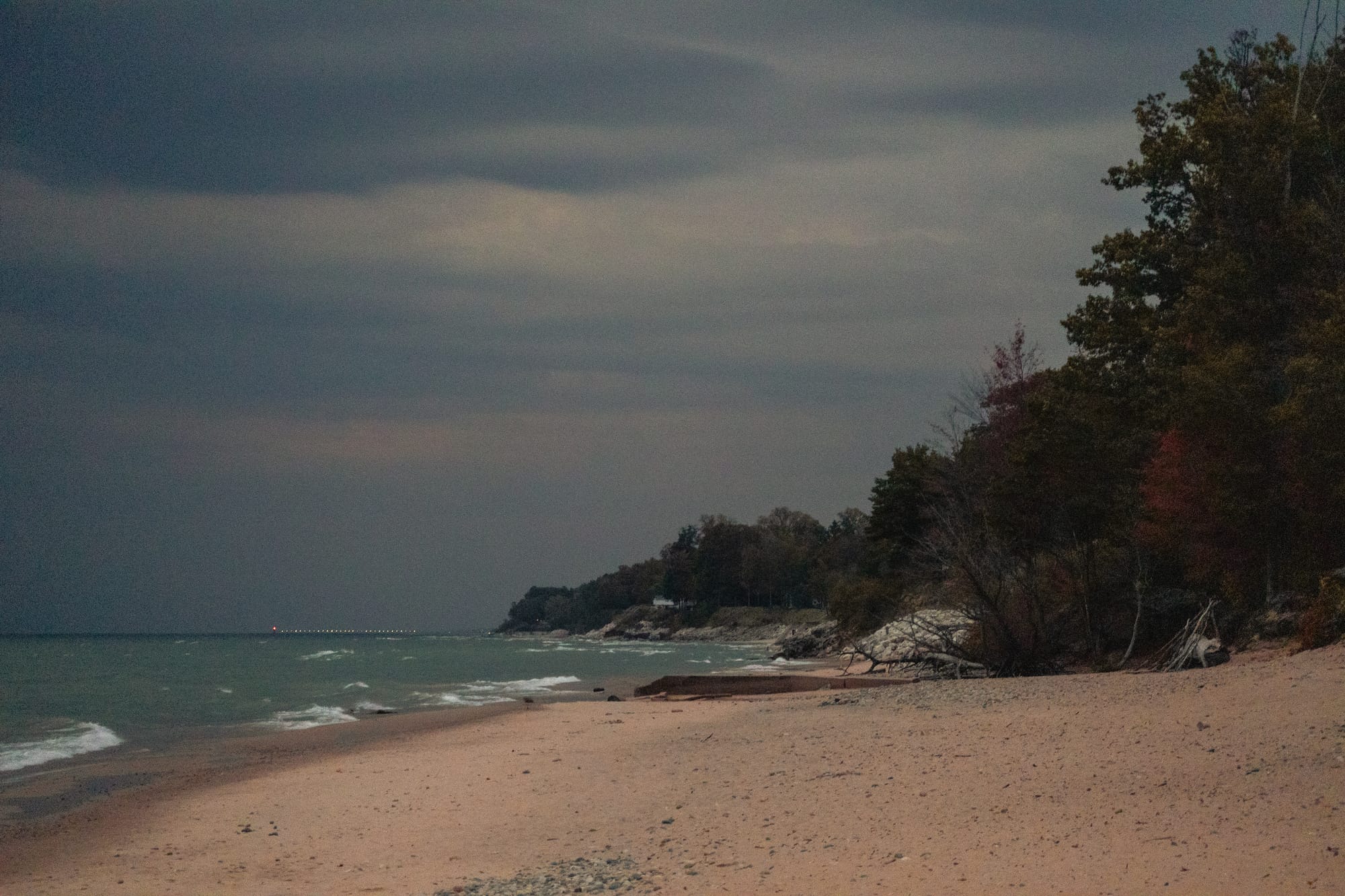 A shot of the sky with a stormy portion and a sunny portion.