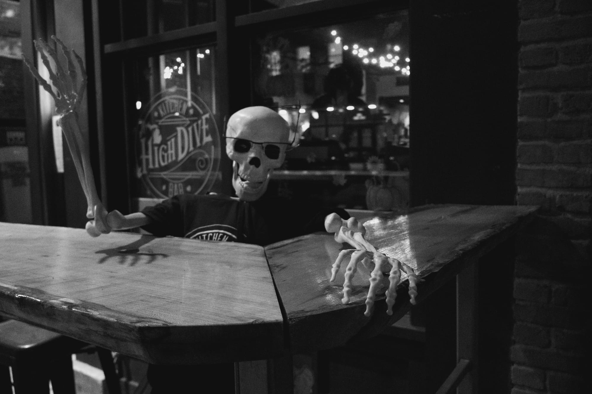 A prop skeleton watches the door at the High Dive bar.