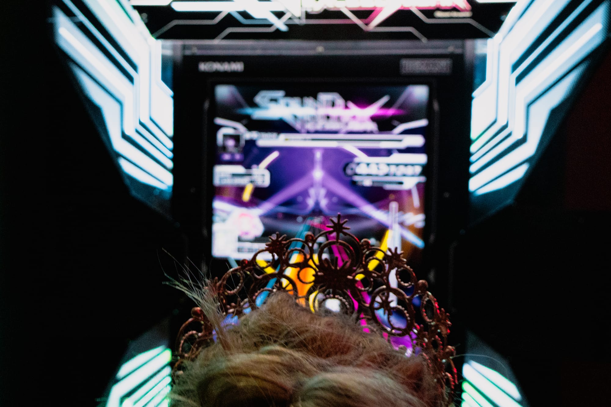 A princess crown in front of an arcade machine.