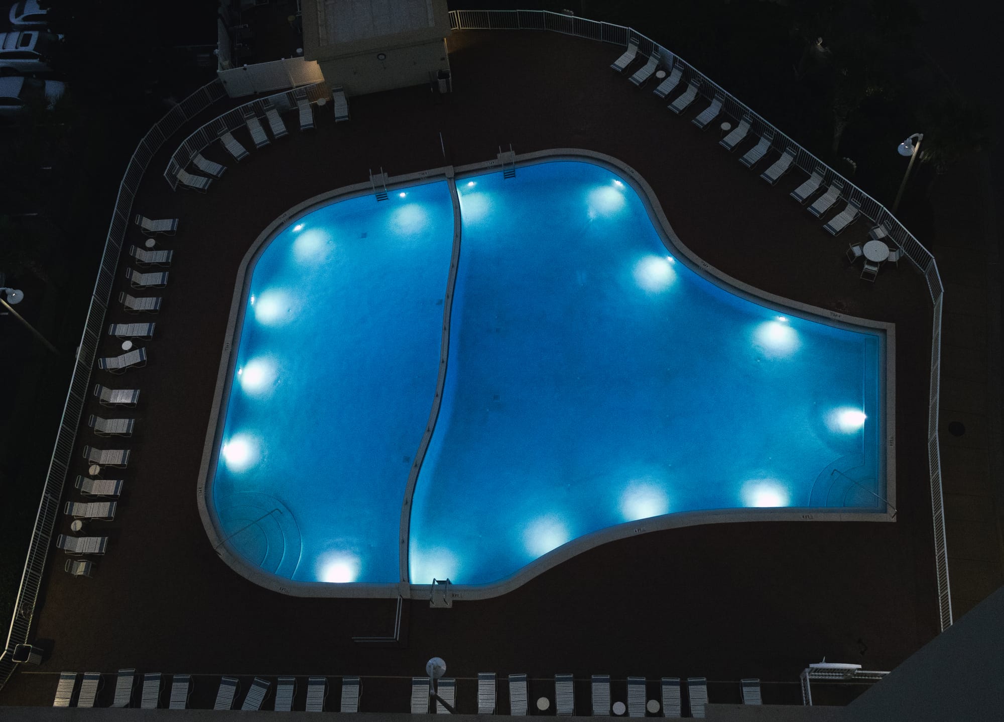 A pool all lit up at night.
